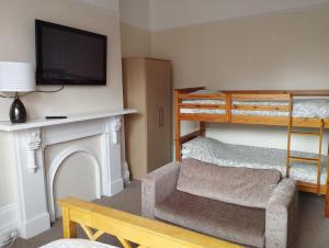 a living room with a chair and a bunk bed at sunnylodge in Folkestone