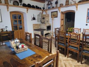 a kitchen and dining room with a wooden table and chairs at Penzion Klopacka in Špania Dolina