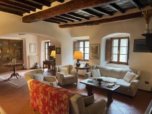 a living room with couches and a coffee table at Villa Pozza di Volpaia in Radda in Chianti