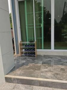 a room with a bunch of wine bottles in a window at เชียงใหม่ บ้านสันติสุข in Ban Ku Sua