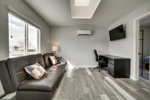 a living room with a couch and a desk at Renovated Hawthorne Apartment By Museums and Dining! in Hawthorne