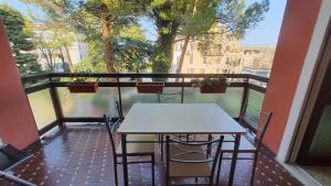two tables and chairs on a balcony with a view at Casa Imma lake, center and everything you need in Desenzano del Garda