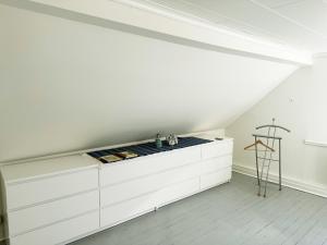 a kitchen with white cabinets and a white ceiling at Nice holiday home in Balsta in Bålsta