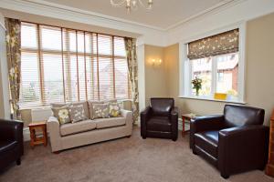 a living room with a couch and two chairs at Camberley House in Sheringham