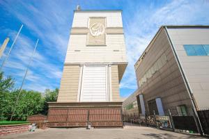 a tower with a clock on it next to a building at GRAND OPERA HOTEL in Almaty