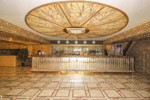 a lobby with a bar with a large ceiling at GRAND OPERA HOTEL in Almaty