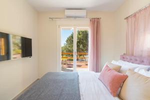 1 dormitorio con cama y vistas a un patio en Sunset Dreams Spyros, en Kalymnos