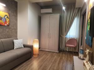 a living room with a couch and a cabinet at Del Gaudio Guesthouse in Torre Melissa