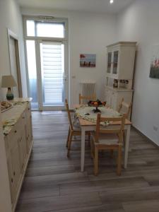 a kitchen with a table and chairs and a dining room at Casa Lucia in Bari