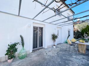 a patio with a table and chairs and a building at Apartments Teodora Maria in Novigrad Istria