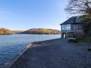 a building on the shore of a body of water at Oakenhurst in Fowey