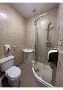 a bathroom with a shower and a toilet and a sink at En-suites Rooms in Northampton in Moulton