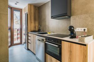 a kitchen with a sink and a stove top oven at MIKKA CLOS in Soldeu