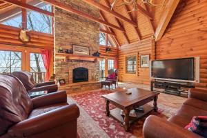 a living room with a television and a fireplace at Rustic Elegance in Boone
