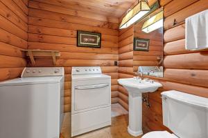 a bathroom with white appliances and a toilet and a sink at Rustic Elegance in Boone +23 photos