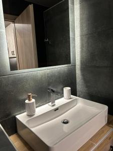 a bathroom with a white sink and a mirror at MSK Rotonda Studio 1 in Thessaloniki