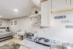 a kitchen with a sink and a bed in a room at Blue Lagoon - Unit B in Tampa