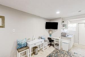 a white room with a desk and a tv at Blue Lagoon - Unit B in Tampa