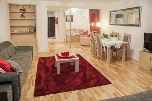sala de estar con sofá y mesa en Apartamenty Czerwone Maki Wisła, en Wisła