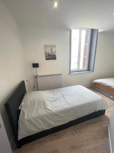 Ένα ή περισσότερα κρεβάτια σε δωμάτιο στο Appartement de la laverie