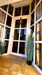 a front door of a house with two potted plants at MP Center Magánszállás in Miskolc