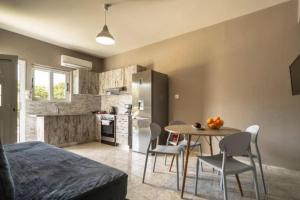 a kitchen and dining room with a table and chairs at Grand view resort in Argostoli