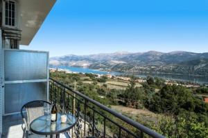 a balcony with a table and a view of a river at Grand view resort in Argostoli