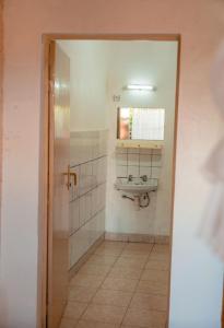 a bathroom with a sink and a mirror at Auberge La Caverne in Kigali