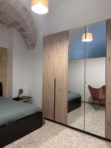 a bedroom with a bed and a glass wall at Annandre in Polignano a Mare