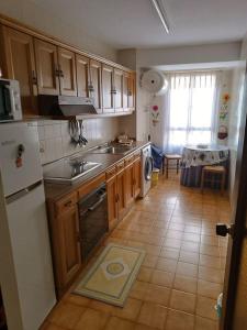 a kitchen with a sink and a dishwasher at Piso centro Luanco in Luanco +16 photos