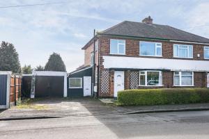 a brick house with a gate and a fence at Gedling Contractors Delight! in Nottingham