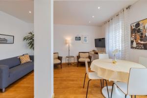 a living room with a table and a couch at Charroque in Setúbal