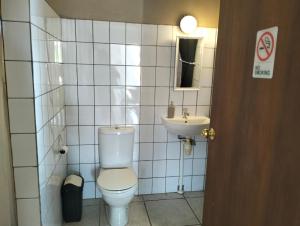 a bathroom with a toilet and a sink at Marilyn Appartments in Kralendijk