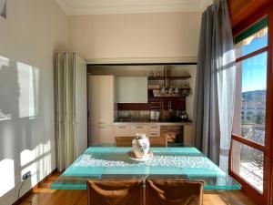 a dining room with a table and a kitchen at La Casa sul Corso in Agropoli