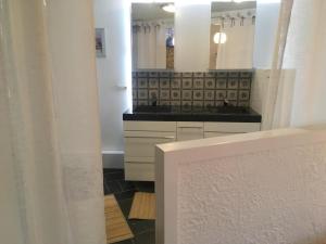 a bathroom with two sinks and a large mirror at La Ferme De Durbuy in Durbuy