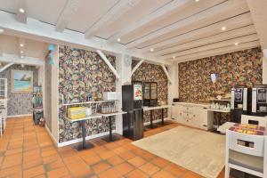 a large kitchen with floral wallpaper on the walls at Brit Hotel Marbella in Biarritz