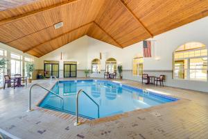 an indoor swimming pool with a wooden ceiling at Cozy Birchwood Condo on Tagalong Golf Course! in Birchwood