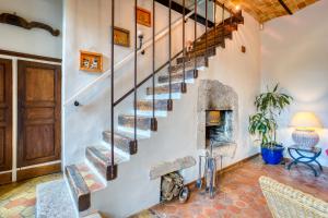 a stone staircase in a house with a fireplace at La Fauconnerie Du Roy in Montainville +28 photos