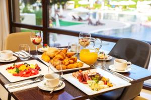 a table with plates of food and glasses of wine at Barcelo Royal Beach - All Inclusive in Sunny Beach