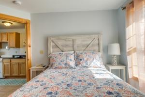 een slaapkamer met een groot bed met een houten hoofdeinde bij Wells Vacation Rental about 1 Mi to Beach Access! in Wells