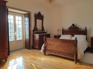 a bedroom with a bed and a dresser and a mirror at Casa do Terreiro in Barqueiros +14 photos