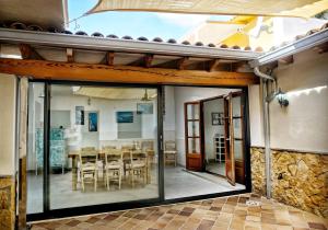 a dining room with glass doors and a table at House Can Toni in Port d'Alcudia