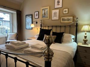 a bedroom with a large bed with towels on it at 1869 - Room Only Boutique Townhouse in Ambleside