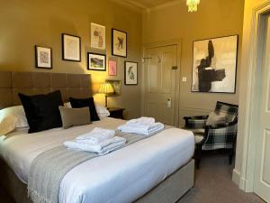 a bedroom with a bed with towels on it at 1869 - Room Only Boutique Townhouse in Ambleside