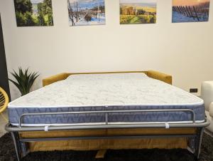 a mattress sitting on a bed frame in a room at Gîte la Winery in Romery