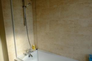 a bathroom with a shower with a tub at Lovely Master Bedroom with King Size Bed in Liverpool