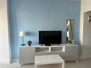 a living room with a tv on top of a cabinet at Mar del Sur Apartments Benalmádena in Benalmádena