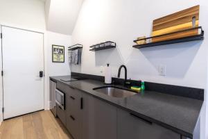 a kitchen with a sink and a counter top at Thena Hotel - Large Studio in Philadelphia