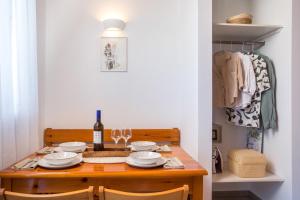 a dining room table with plates and wine glasses at Margaritas apartments in Symi