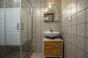 a bathroom with a sink and a mirror at Margaritas apartments in Symi